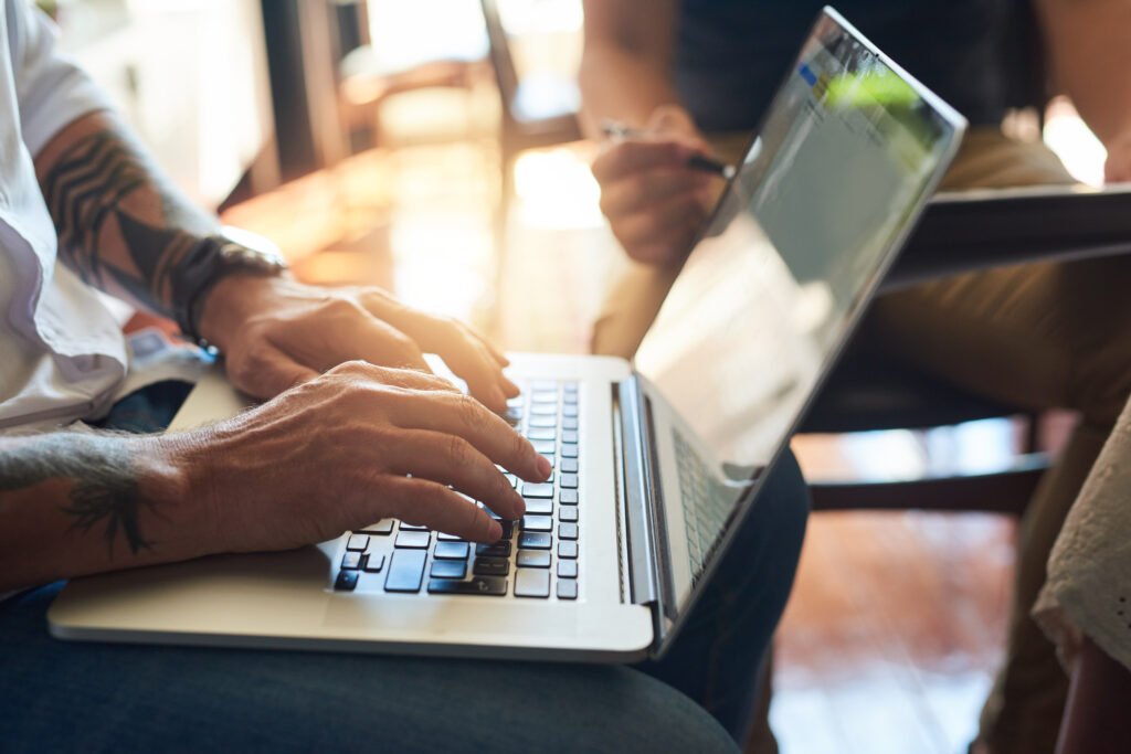 Man, hands and typing on creative laptop, web design and developer in startup career or working on business website. Prototyping, browse and online project with people, internet and social networking.